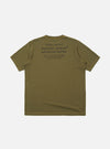 The master-piece x Universal Works Olive Single Jersey Print Tee is shown from the back as a flat lay against a white background. The image highlights the large graphic print on the upper back, featuring a geometric mountain-like design and collaborative branding. The t-shirt has a classic crew neck and short sleeves.