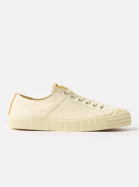 Side view of the Novesta for Universal Works Ecru Canvas Star Master shoe on a white background. The shoe is made of ecru canvas with a rubber sole.