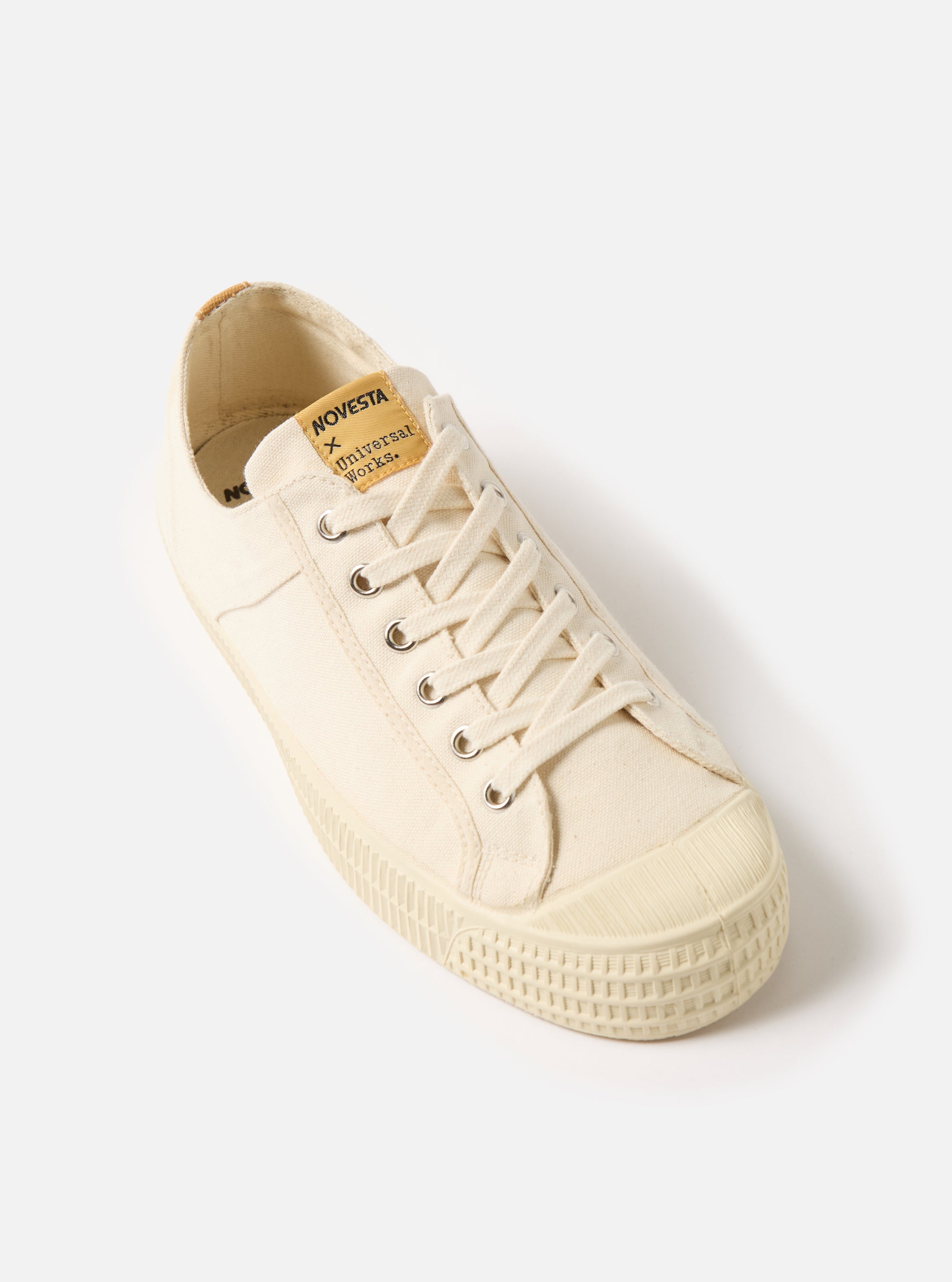 Studio shot of the Novesta for Universal Works Ecru Canvas Star Master. The ecru canvas shoe is on a white background.
