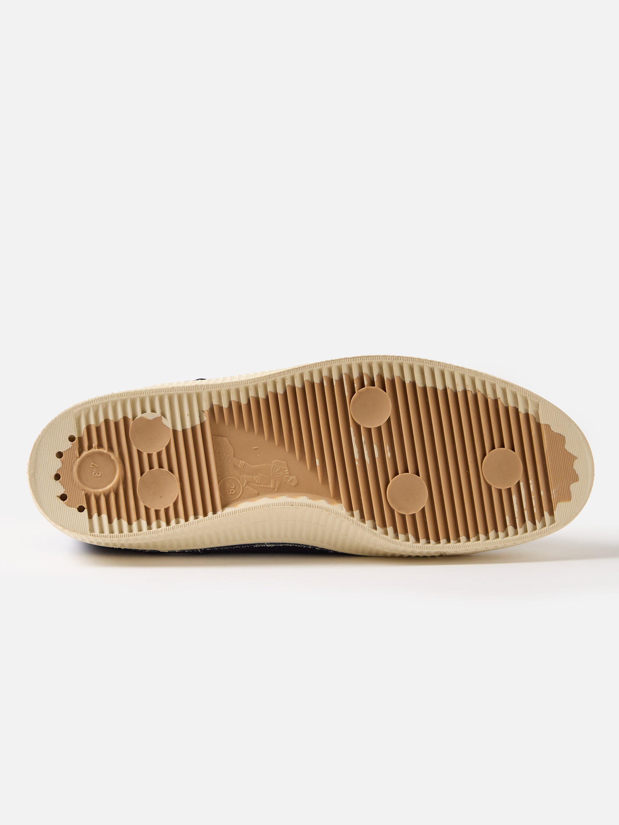 Close-up of the sole of the Novesta for Universal Works Navy Canvas Star Master shoe, showing the brown rubber sole with a textured pattern, on a white background.