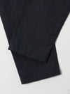 Close-up of the Navy Linen Slub Weave Military Chino on a white surface. The navy color and linen texture are visible.