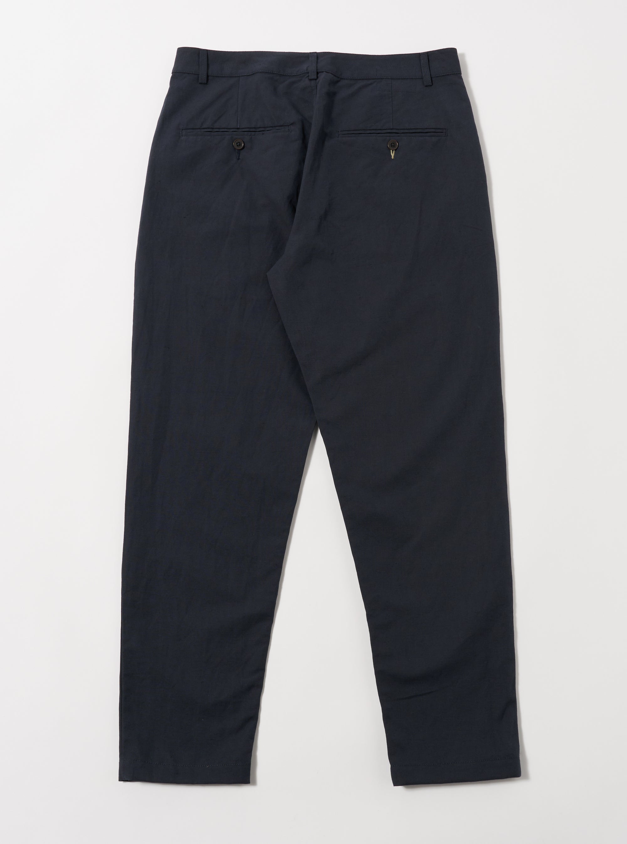Back view of Navy Linen Slub Weave Military Chino pants on a white background. The pants are a relaxed fit and made of a textured linen.