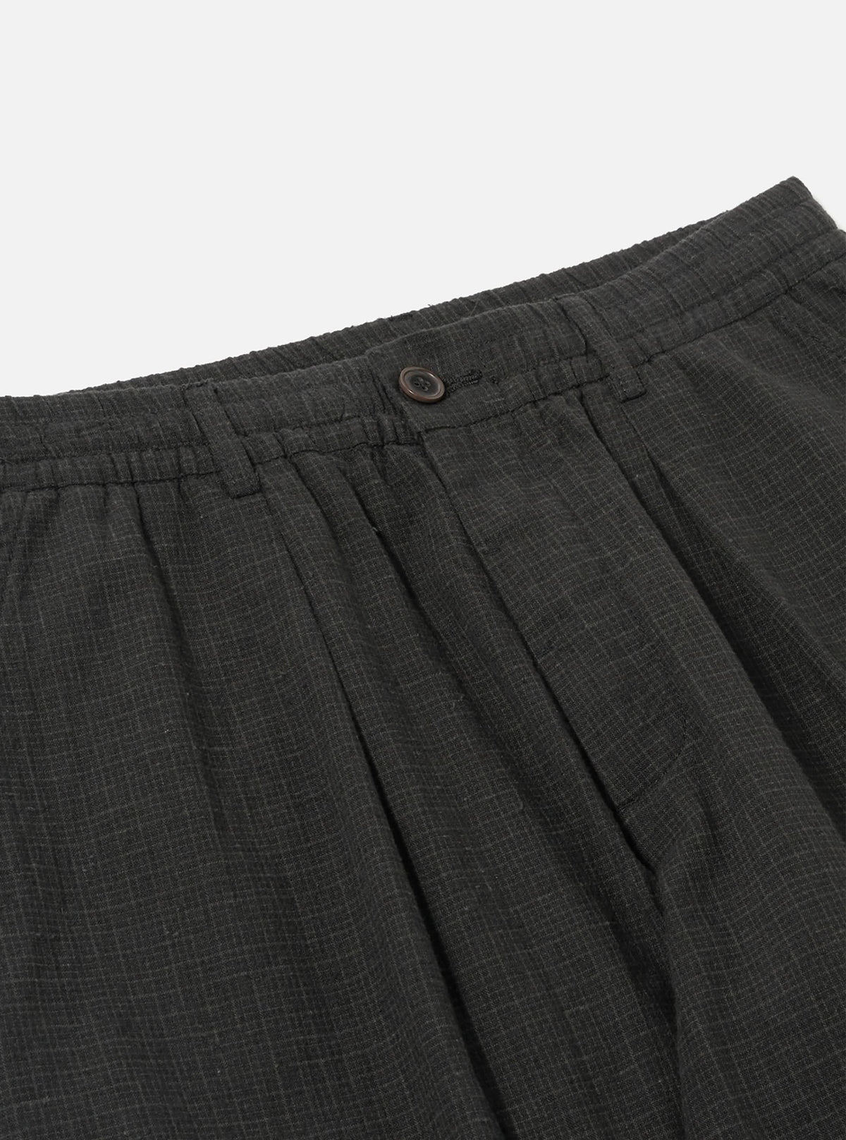 Close-up of the Charcoal Fine Linen Mix Pleated Track Pant on a white background, showing the waistband, button, and pleats.