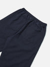 Close-up of the back of navy cotton Judo Pant on a white surface. The pants have an elastic waistband and two back pockets.