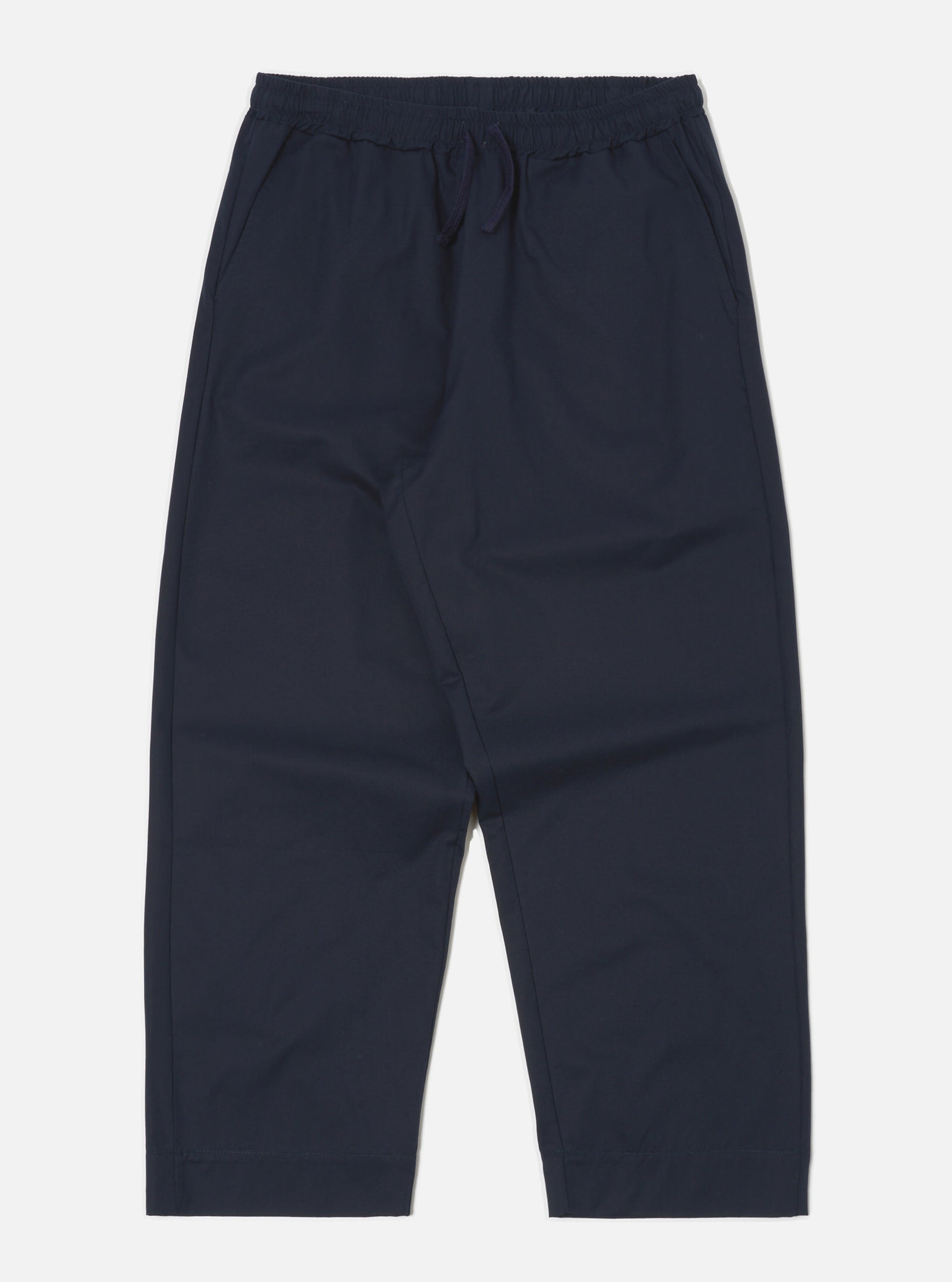 Studio shot of the Navy Military Cotton Judo Pant on a white background. These loose-fitting, navy cotton pants feature an elastic waist with a drawstring.