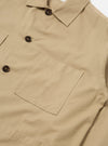 Close-up of the Sand Military Cotton Dockside Overshirt, showcasing its sand color, cotton material, button details, and pocket. Shot on a plain white background.