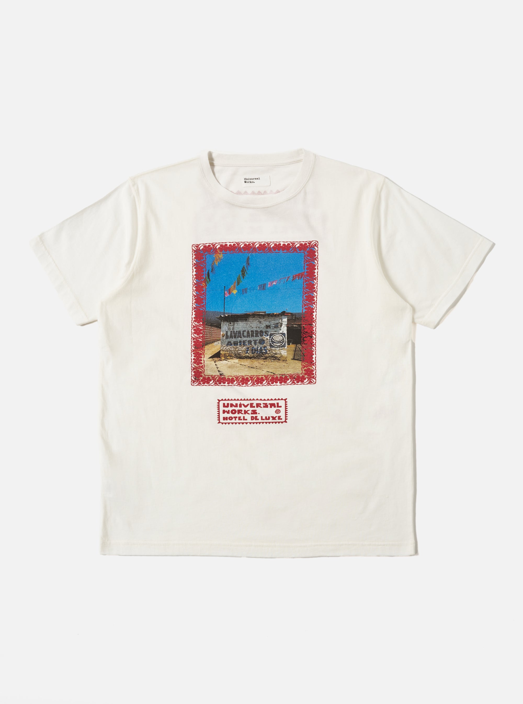 The Ecru/Red Single Jersey Pickup Print Tee on a white background. The tee is ecru with a red print of a building and text. The jersey material looks soft and comfortable.