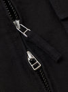 Close-up of the zipper on the Black Organic Canvas S130 Jacket. The black canvas material is visible, along with the silver zipper pull.