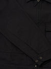 Close-up of the sleeve of a Black Organic Canvas S130 Jacket, showing the elbow patch, buttons, and canvas texture. Shot on a plain background.