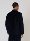Back view of a model wearing a Navy Velveteen Two Button Jacket in front of a plain white background. The jacket is a rich navy color and appears soft.