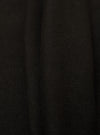 Close-up of the Black Single Jersey Funnel Neck Tee fabric. The soft, black jersey material is draped to show texture. Simple studio background.