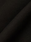 Close-up of the Black Brush Back Sweat New York Hoody fabric. The soft, black material is folded, showcasing its texture and quality.