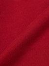 Close-up of the red, textured fabric of the Red Brush Back Sweat New York Hoody. The material is folded, showing the weave. Background is a plain surface.