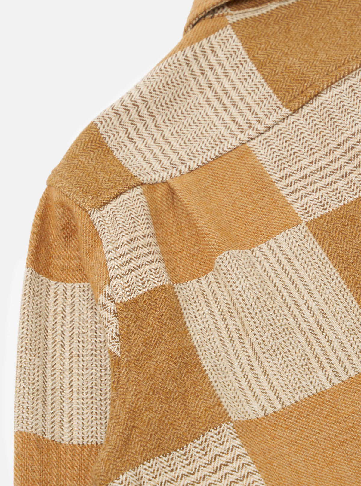 Close-up of the Sand Japanese Patchwork Easy Jacket showing the textured fabric in tan and cream tones. The jacket is on a white background.