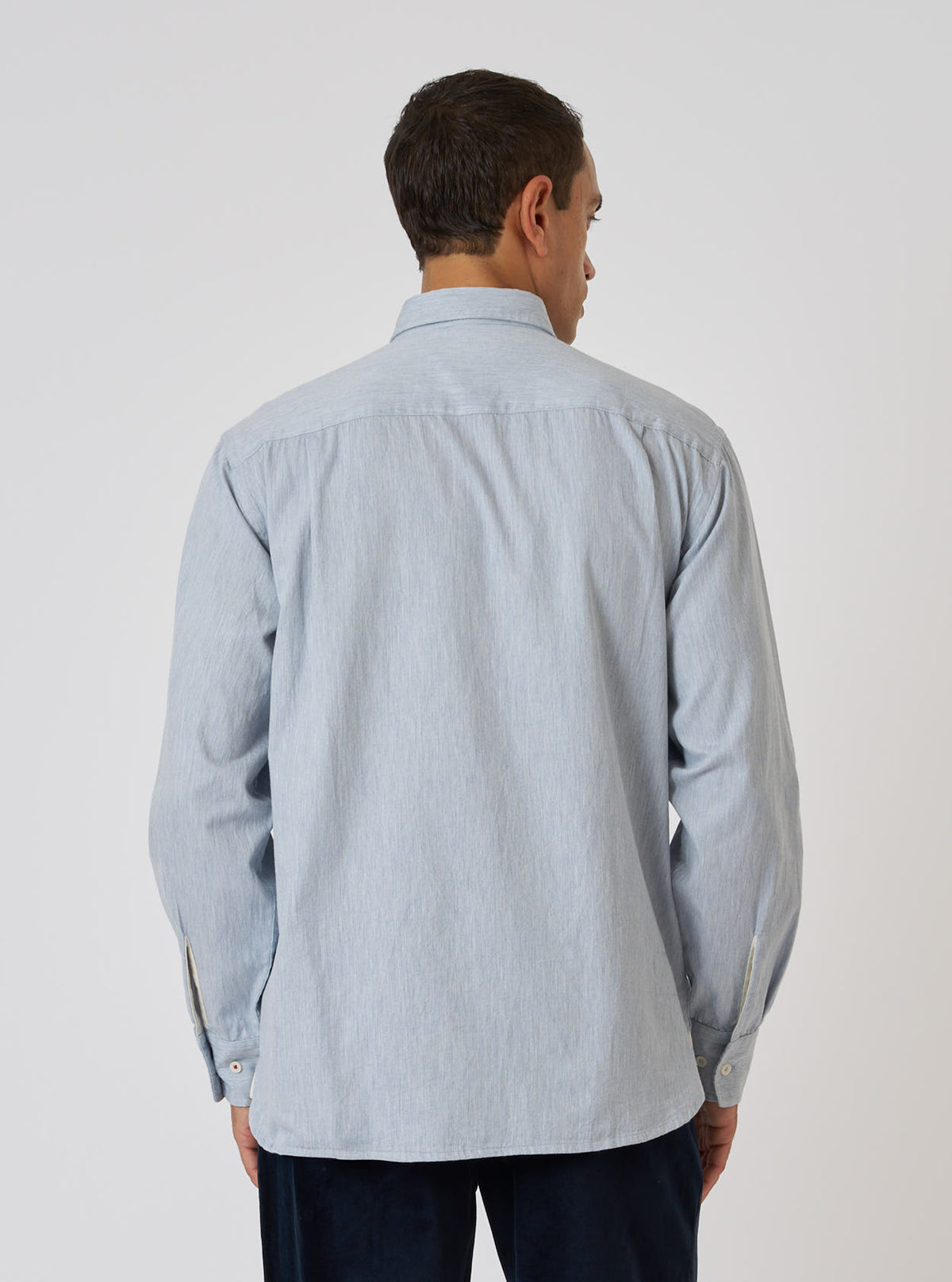 Back view of a model wearing a Sky Blue Brushed Organic Cotton Square Pocket Shirt. The shirt is on a white background.