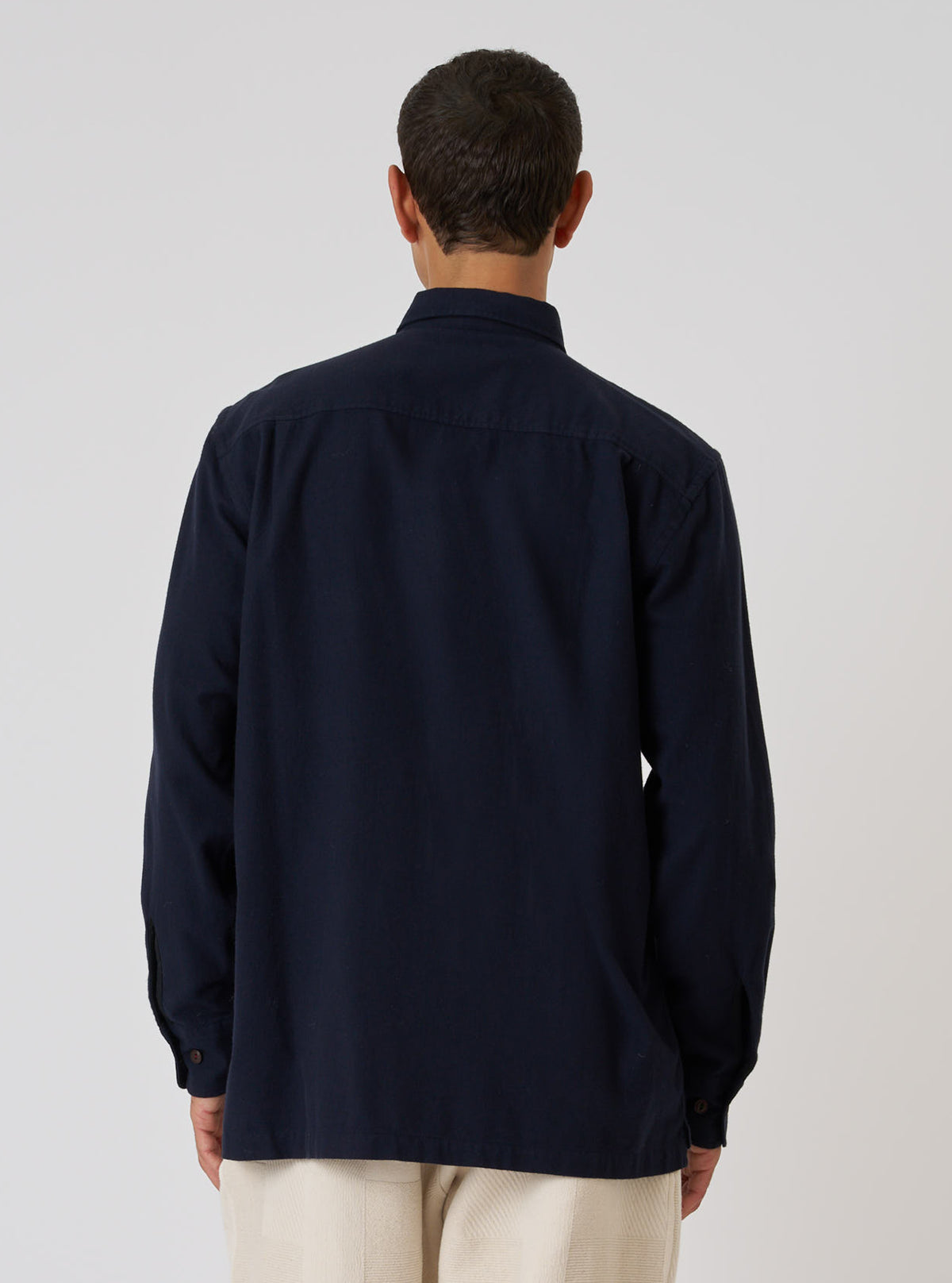 Back view of a model wearing a Dark Navy Sid Flannel CPO Shirt against a white background. The shirt is a dark navy color and appears to be made of soft flannel.