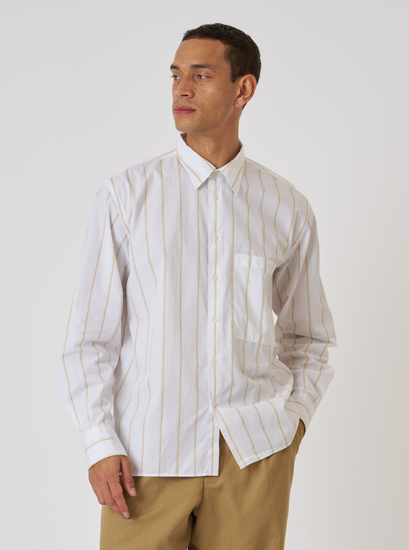A man models a White Office Stripe Square Pocket Shirt against a plain background. The shirt is white with thin gold stripes and a square pocket.