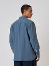 Man on white background, back view, wearing a Blue Brushed Marl Twill Square Pocket Shirt. The shirt is a relaxed fit.