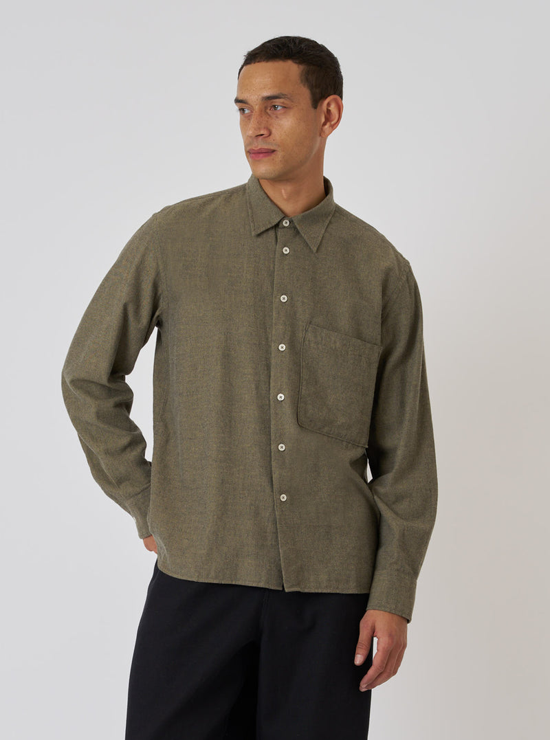 A model poses in a Mustard Brushed Marl Twill Square Pocket Shirt. The shirt is a textured mustard color with a square pocket. The background is a plain white backdrop.