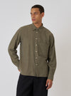 A model poses in a Mustard Brushed Marl Twill Square Pocket Shirt. The shirt is a textured mustard color with a square pocket. The background is a plain white backdrop.