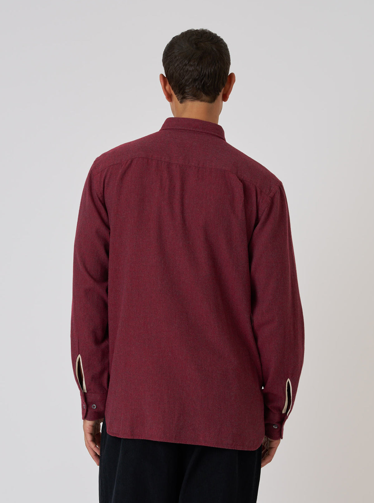Back view of a model wearing the Red Brushed Marl Twill Square Pocket Shirt. The shirt is a deep red color and made of a textured twill material. Shot against a plain white backdrop.