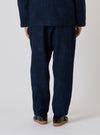 Back view of a model wearing Black/Indigo Denim Camo Pleated Track Pant on a white background. The denim pants have a loose fit and subtle camo pattern.