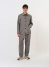 The Mid Grey Linen Slub Weave Bakers Jacket is shown laid flat against a solid white background. The jacket features a classic pointed collar, a full button-down front, and four prominent patch pockets, including one on the chest and three on the lower body. The mid-grey fabric has a visible slub texture.