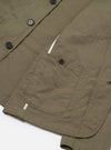 The Olive Linen Slub Weave Bakers Jacket is shown from the back as a flat lay against a plain white background. The image highlights the jacket’s straight hem, simple one-piece back panel, and the textured olive green linen slub fabric.