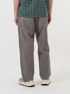 A model is wearing the Mid Grey Linen Slub Weave Oxford Pant against a plain white background. The image, captured from the rear, highlights the loose, wide-leg fit of the grey trousers, showing the elasticated waistband and one of the back pockets. No other garments are visible.