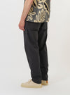 A model is shown from the waist down wearing the Charcoal Seattle Cotton Military Chino against a plain white background. The image provides a side-rear view of the trousers, highlighting the straight-leg fit and a single buttoned flap pocket on the back. The model is also wearing navy blue shoes.