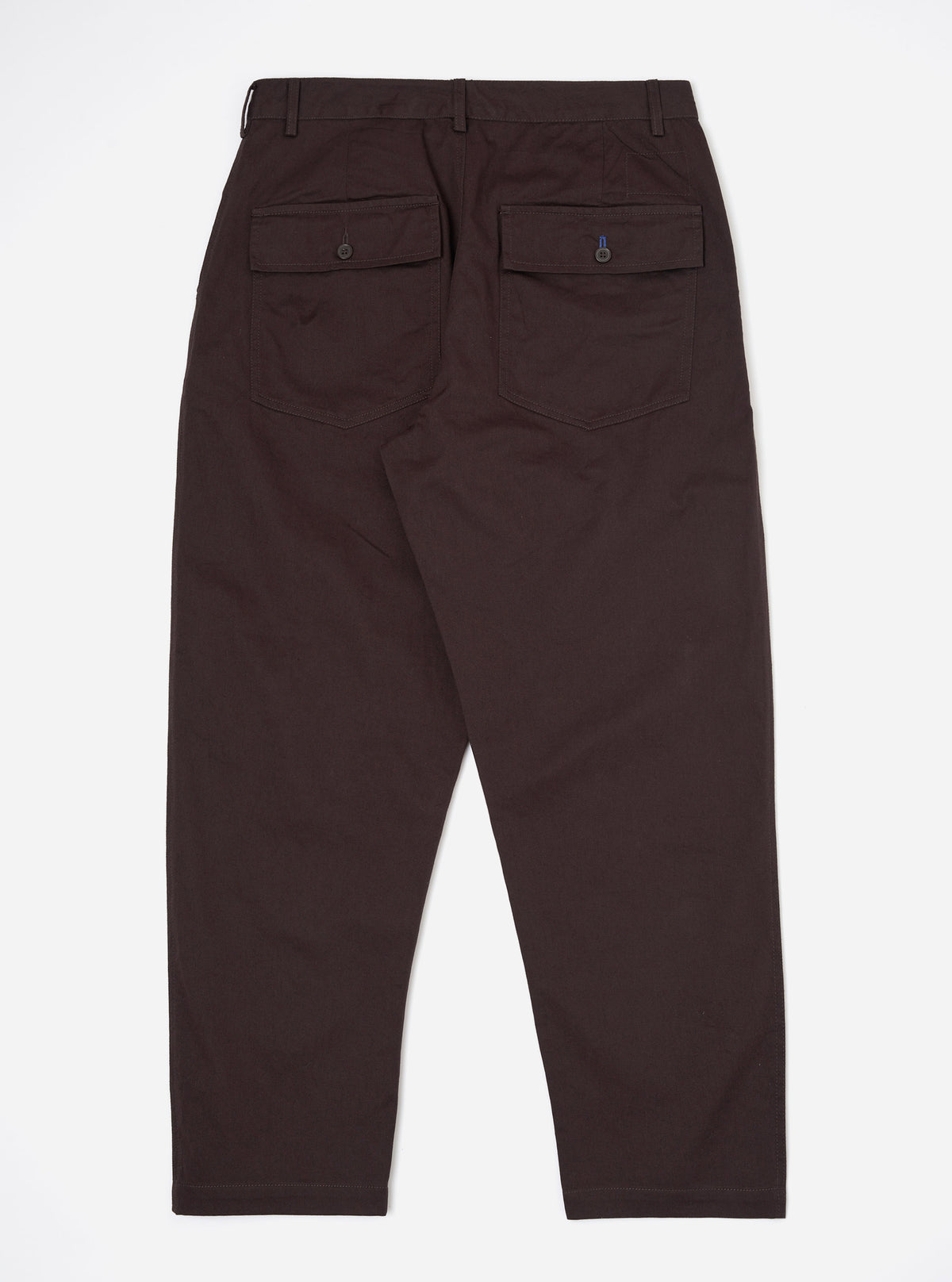 A pair of Brown Twill Dizzy Trousers is shown from the back, laid flat against a plain white background. The trousers feature a wide, slightly tapered leg and two prominent rear patch pockets with buttoned flaps.