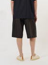 A model is wearing the Brown Marl Tropical Suiting Vacation Short against a plain white background. The shorts feature a relaxed fit and a mid-thigh length, with the marled brown fabric texture clearly visible. The model is standing, showing the front and side profile of the garment.