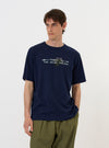 The Navy Single Jersey Trail Trail To Hotel Delux Tee is displayed flat against a plain white background. The navy blue t-shirt features a crew neck, short sleeves, and a white graphic print on the chest that reads Trail To Hotel.