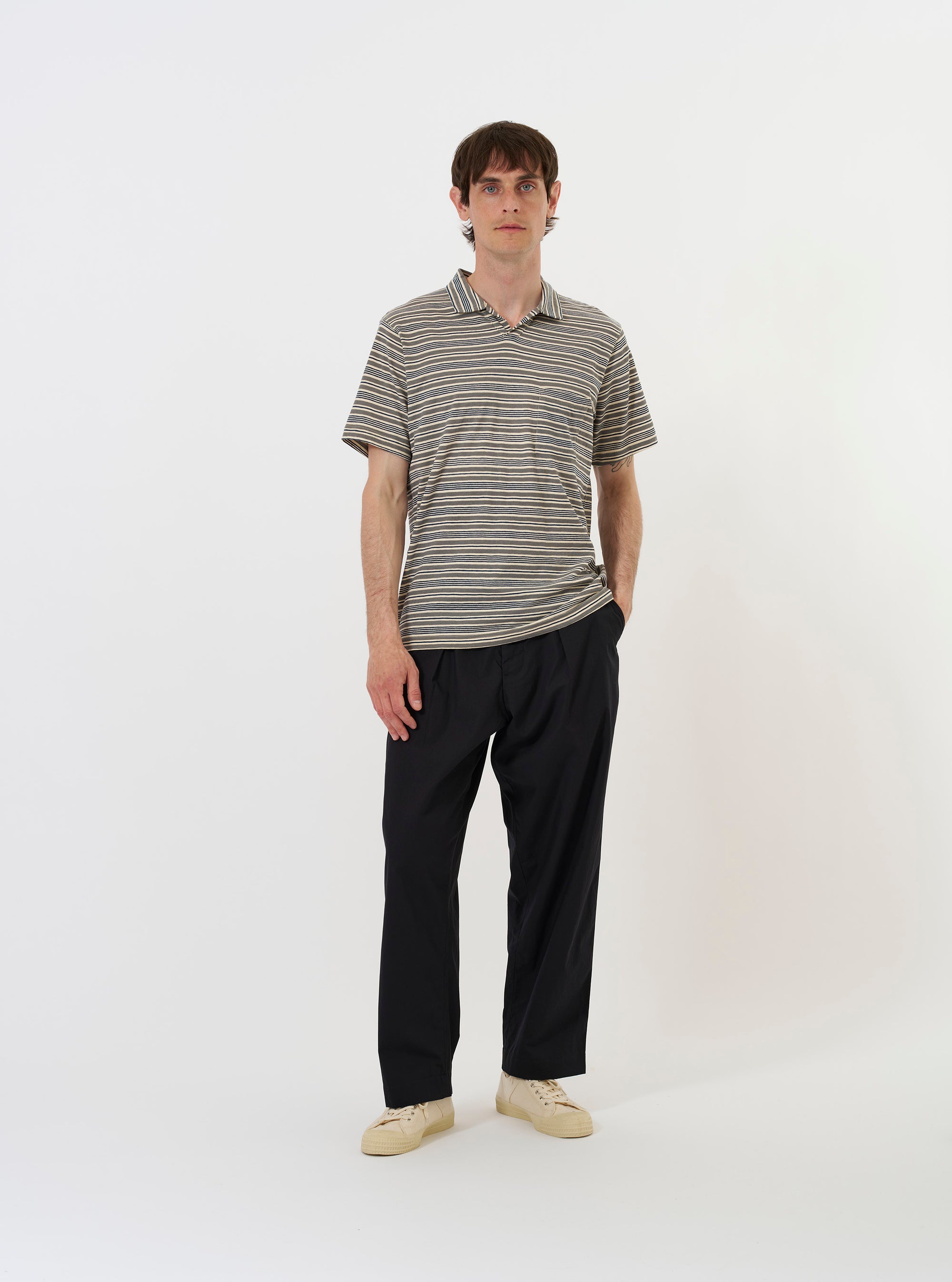 The Grey OS Stripe Jersey Vacation Polo is shown from a rear perspective, laid flat against a solid white background. The image highlights the horizontal grey and white stripes, the straight hem, and the back of the classic polo collar.