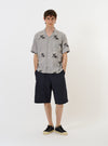 The Grey Hand Embroidered Stripe Cotton Road Shirt is shown laid flat against a solid white background. The shirt features a camp collar, a button-down front, and short sleeves. The grey cotton fabric is detailed with delicate, hand-embroidered vertical stripes.