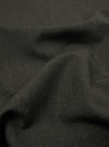A close-up fabric swatch of the Olive Marl Tropical Suiting material used for the Two Button Jacket shows a detailed weave with a blend of green and grey tones. The image highlights the smooth, professional texture of the polyester-wool fabric.