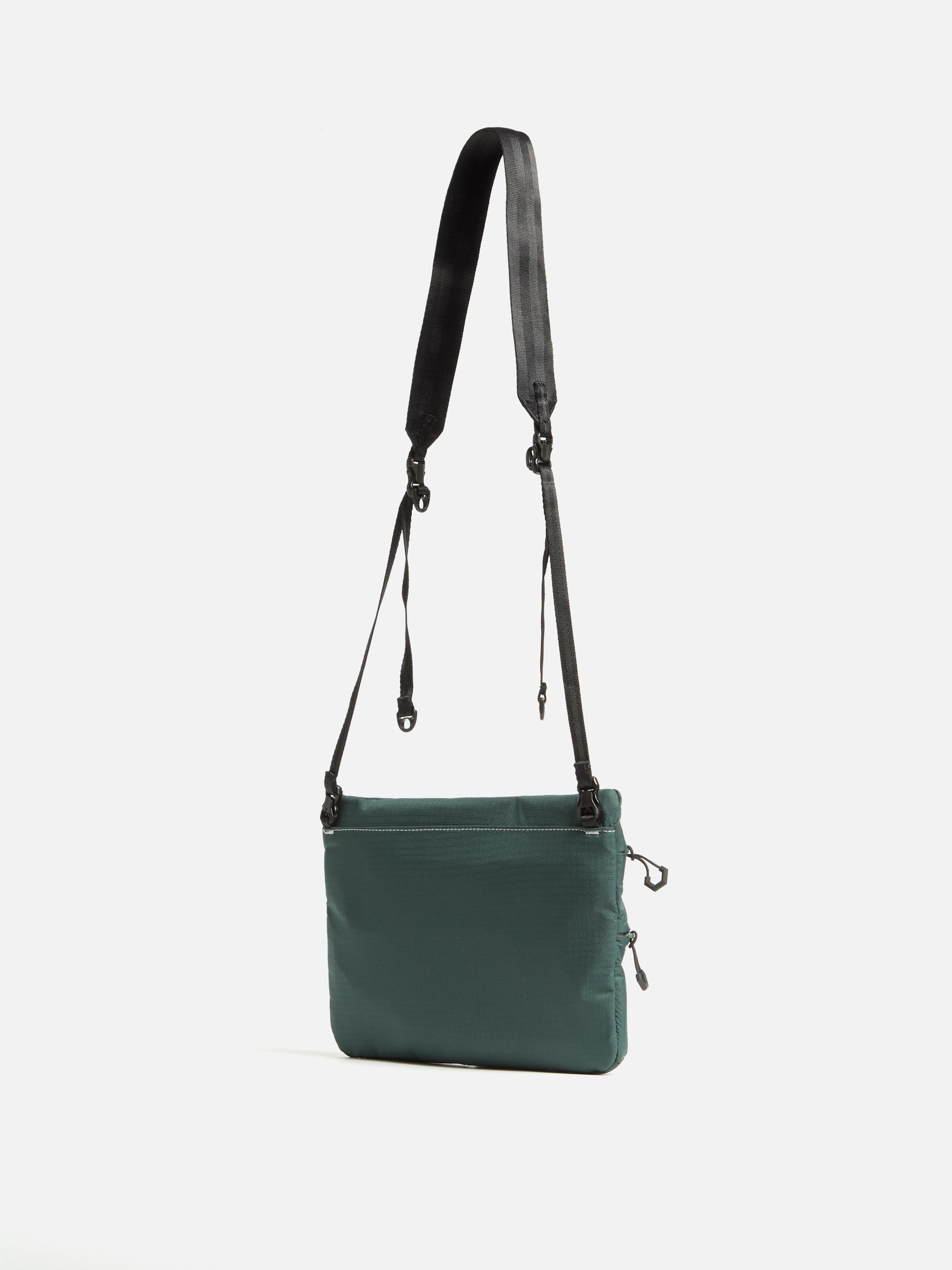 The F/CE.® Green Nylon 2.5 Layer Sacoche, a compact bag with a black strap, is displayed against a white background. The bag is made of green nylon material.