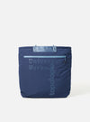 The Topologie x Universal Works Insignia Blue UW Tech Helmet Bag. A blue padded bag with 'Universal Works' and 'Topologie' printed on the front. Shot on a white background.