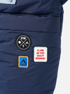 Close-up of the Topologie x Universal Works Insignia Blue UW Tech Helmet Bag. Features patches on the blue material. Shot against a white backdrop.