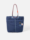 Topologie x Universal Works Insignia Blue UW Tech Helmet Bag on a white background. The bag is puffy with rope handles and patches.