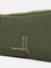 Close-up of the Topologie x Universal Works Rifle Green UW Tech Bottle Sacoche Medium. Features olive green material with beige straps and logo detailing on a white background.