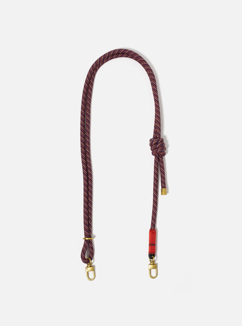 Topologie x Universal Works Olive Hitch UW Rope 8mm Strap on a white background. The rope is red and navy with gold hardware.