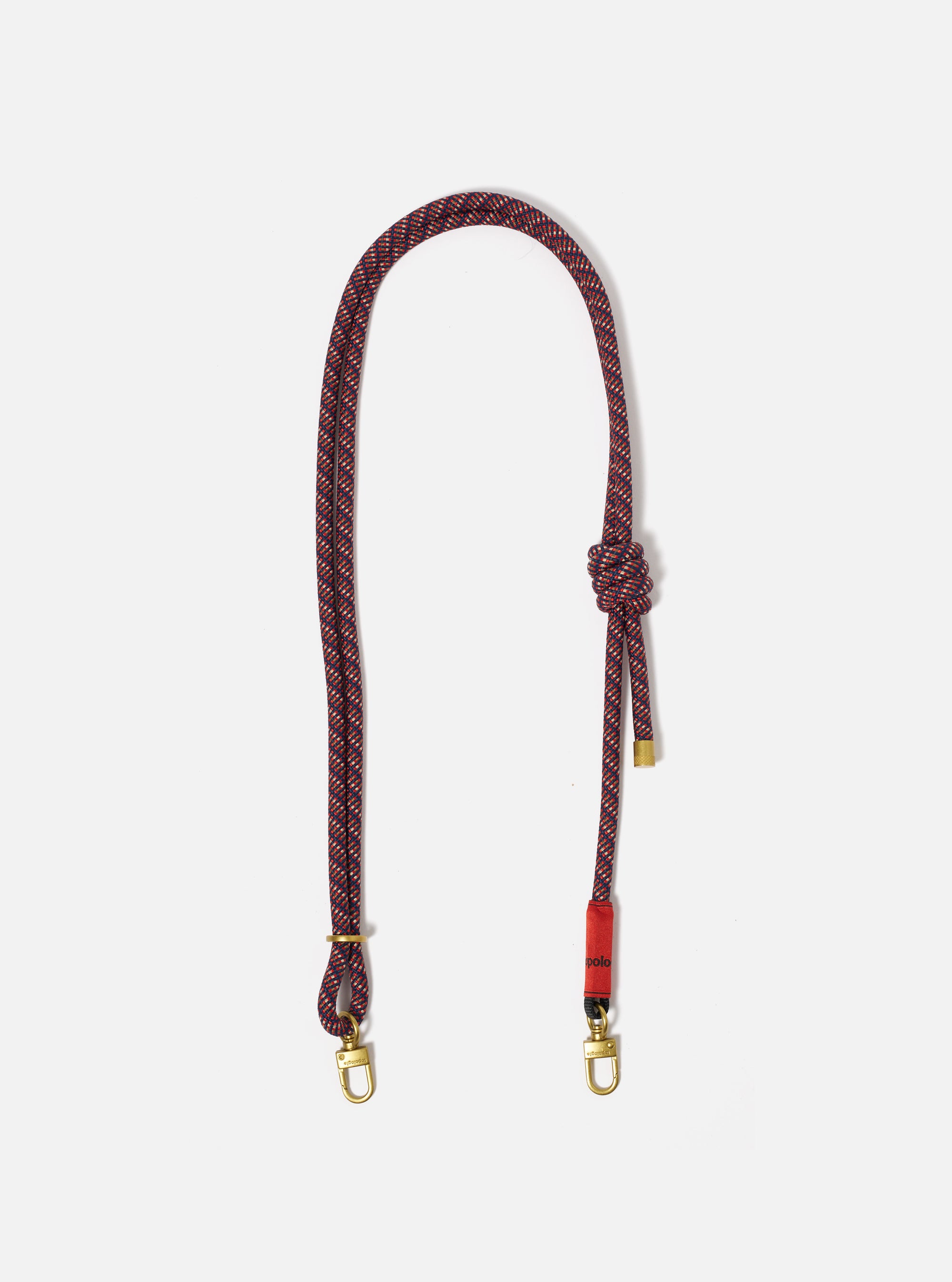 Topologie x Universal Works Olive Hitch UW Rope 8mm Strap on a white background. The rope is red and navy with gold hardware.