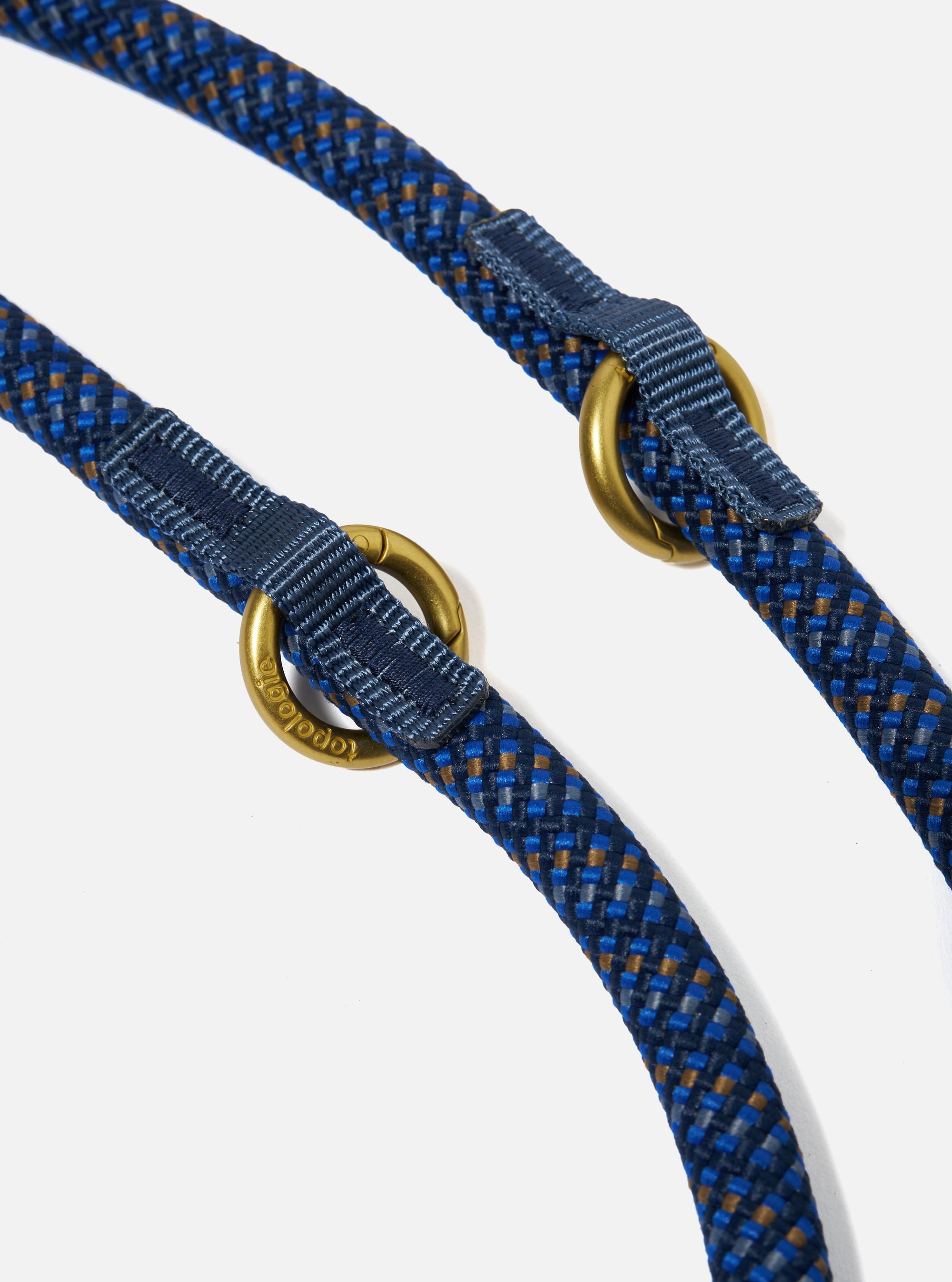 Close-up of the Topologie x Universal Works Navy Hitch UW Rope 10mm Rope Loop on a white background. The rope is navy with blue and brown accents and has gold metal loops.
