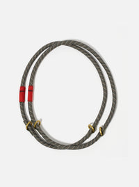 Topologie x Universal Works Olive Hitch UW Rope 10mm Rope Loop on a white background. The rope is olive with blue and tan accents and has red fabric and gold metal details.