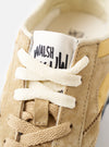 A pair shot showing both left and right shoes of the Walsh x Universal Works Tornado in Beige Leather/Canvas side-by-side on a plain white background, displaying the overall retro runner design.