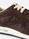 A top-down overhead view of the Walsh x Universal Works Tornado sneakers in brown leather and canvas on a plain white background, highlighting the brown laces, branded insoles, and streamlined toe box structure.