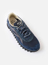 An angled pair view of the Walsh x Universal Works Ensign in Navy Leather/Canvas sneakers displayed on a solid white background, detailing the navy laces, trim, and layered upper design.