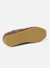 An angled view of the underside sole of the Walsh x Universal Works Cob in Brown Leather trainer against a plain white background, displaying the classic indoor running flat grip pattern and gum rubber finish.