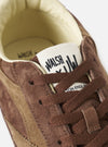 Detailed close-up view of the Walsh x Universal Works Cob in Brown Leather, showing the textured grain leather upper, subtle stitching details, and soft collar trim against a clean, off-white studio background.